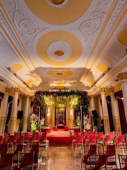 We transformed this palace hall into a regal wedding venue, using rich colors and grand floral arrangements to complement the magnificent architecture and create an atmosphere of royal elegance.