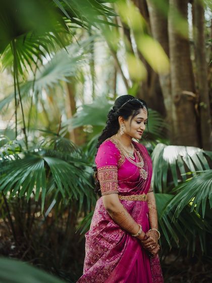 A stunning solo shot of Surabhi during her Varapooja. The natural setting beautifully complements her traditional look.