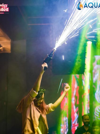 A guest operating a confetti gun, adding to the party's excitement.