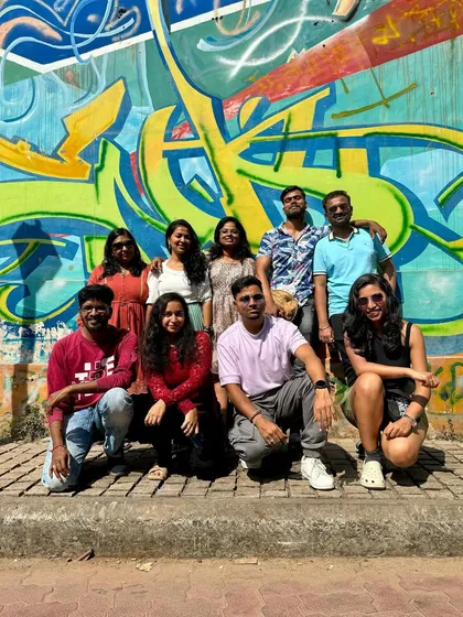 The full Kannur crew posing against a vibrant graffiti wall. A colorful end to a culturally rich trip.