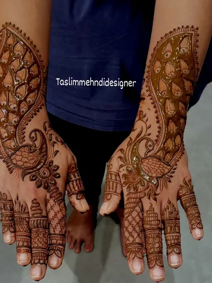 This design focuses on a bold peacock motif that extends from the wrist down the hand. The feathers are filled with intricate details, creating a striking and elegant look.