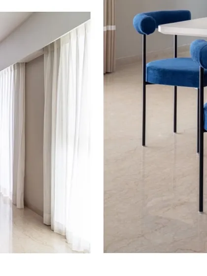 A study in contrasts. The soft, sheer white curtains create a light and airy feel, while the bold, sculptural form of the blue velvet dining chair provides a strong anchor.