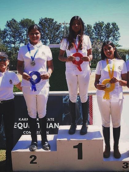 A group of my female riders on the podium at the Karnataka State Equestrian Competition. I am proud to train and support strong, successful women in this demanding sport.