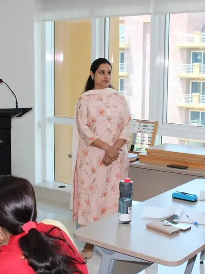 A trainee stands to ask a question during a theory session. Our online classes are live and interactive, encouraging discussion and ensuring that all your doubts about child development and Montessori principles are addressed by our experienced faculty.