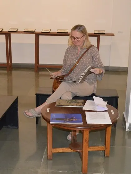 A visitor enjoying one of the books accompanying the 'Quieter than Silence' exhibition.