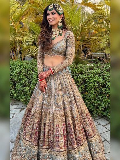 A full-length shot showing her complete look against a lush green background.