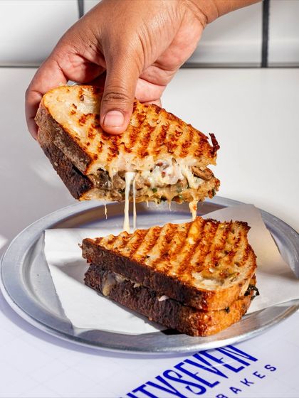 The Cheesy Mushroom Melt is a vegetarian dream. Our seeded sourdough is loaded with a mint pesto, a rich mushroom and cheese mix, pickled red onion, and feta.