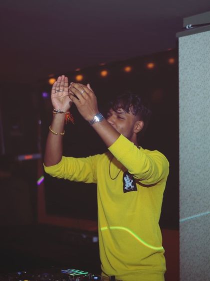 Clapping along with the crowd, creating a shared moment of energy and fun.