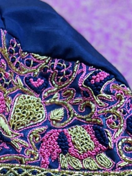 The delicate curves of the peacock motif are brought to life with fine gold thread. It’s this attention to detail that makes my hand-embroidered blouses special.