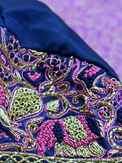 The delicate curves of the peacock motif are brought to life with fine gold thread. It’s this attention to detail that makes my hand-embroidered blouses special.