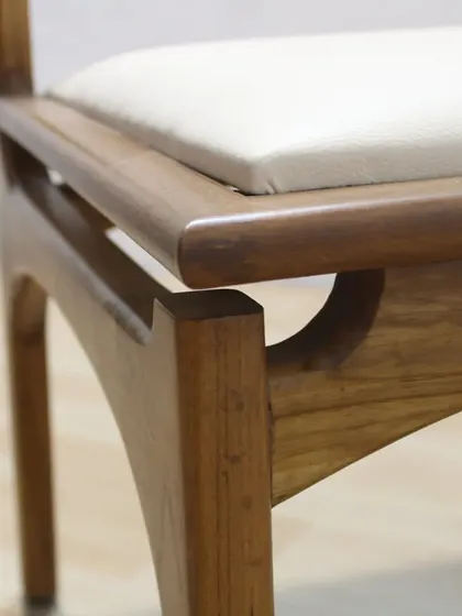A close-up of the joinery where the leg meets the seat frame. These small details are a hallmark of quality, handcrafted furniture.