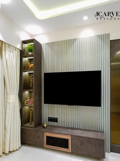 A close-up of a custom TV unit. We combined a sleek console with a vertical display shelf featuring built-in lighting, providing a stylish way to showcase decor and trophies.