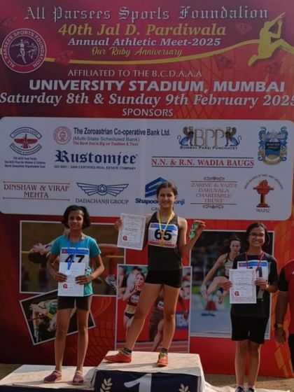 Linn on the podium after dominating the U-12 girls' category with gold medals in the 100m, 300m, and long jump.