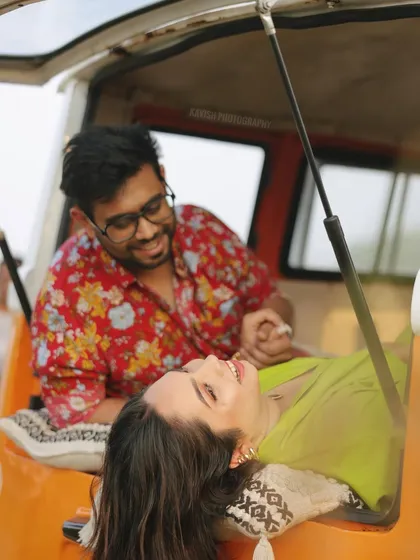 A fun and candid pre-wedding shot of a couple sharing a laugh in the back of an auto-rickshaw, showcasing a unique and playful theme.