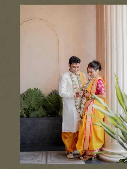 A quiet moment between the bride and groom during their Maharashtrian wedding ceremony, captured in a classic portrait style.