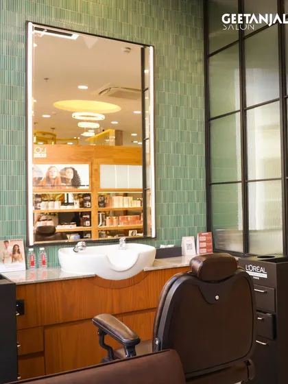 This shot from our Jamshedpur salon highlights the dedicated barbering station, complete with a classic barber chair and a modern, industrial-chic design.