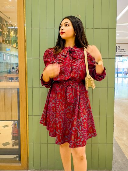 A close-up showing the pussy-bow detail and the print of the dress.