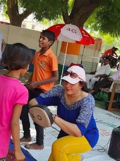 A young boy's excitement is clear as he learns to strike the pads. My goal is to make every child feel powerful and capable.