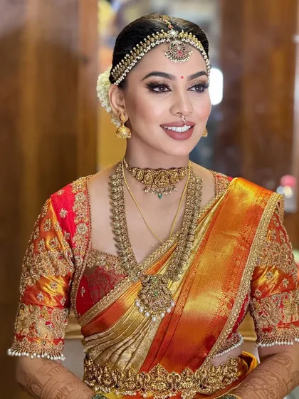 A side profile that highlights the elegant hairstyle and the intricate details of her temple jewelry.