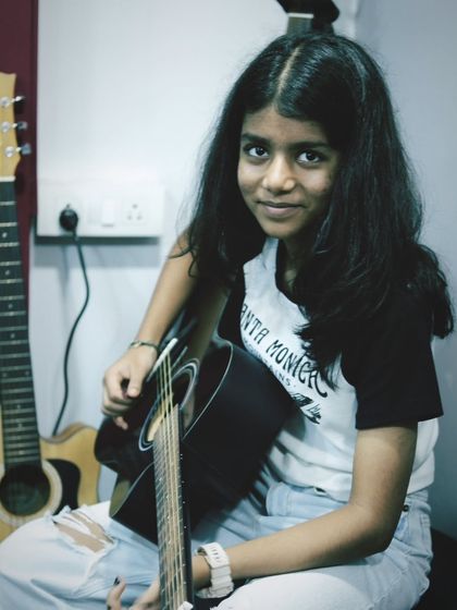 A candid portrait of one of our guitar students, ready for her lesson. We aim to create a space where students feel comfortable and inspired.