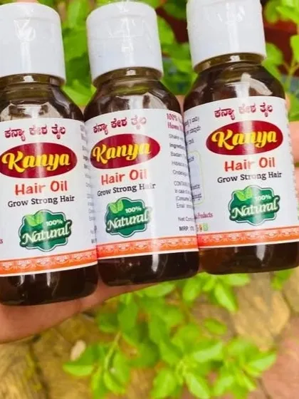 A close-up of three bottles, showing the rich color and handmade quality of the oil.