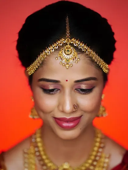 A beautiful shot focusing on the bride's eyes and radiant smile. The makeup is subtle and enhances her natural beauty.