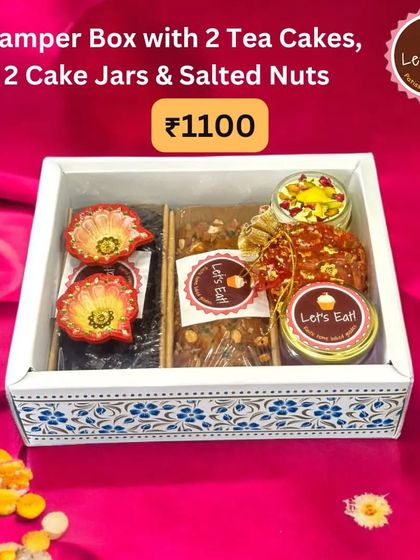 Another look at the popular hamper box containing tea cakes and cake jars, showcasing its elegant presentation against a vibrant background.