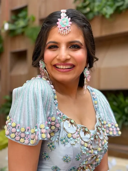 A close-up of the makeup, featuring a soft smokey eye and a bright, happy smile.