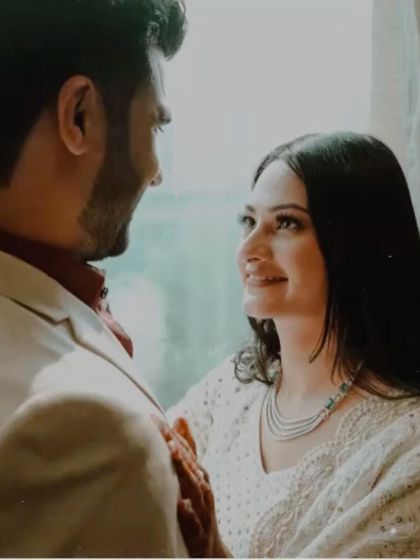 A soft and intimate close-up capturing the loving gaze between a newly engaged couple, highlighting the beautiful details of her jewelry and the emotion in her eyes.