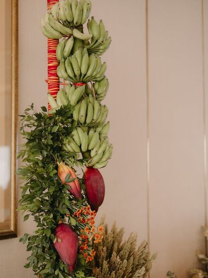 Traditional elements like banana leaves and flowers are used to create beautiful, symbolic decor for the start of the wedding celebrations.
