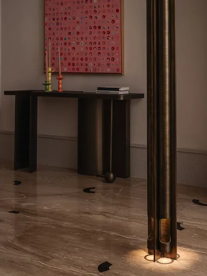 A detail shot of our 'Dash and Dot' console, paired with a vibrant piece of art. The console's simple form and intricate joinery make it a versatile piece that can stand alone or serve as a canvas for other objects.