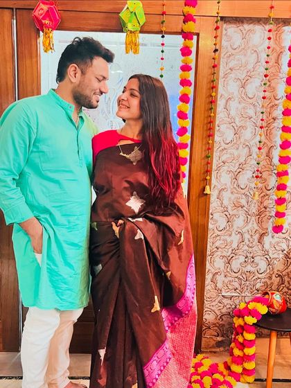 A sweet moment with my husband during Diwali. This brown silk saree with a contrasting pink blouse is a great example of mixing and matching to create a unique look.