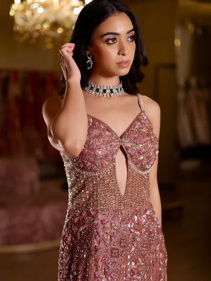 A full-length shot showing how the soft glam makeup works with a heavily embellished gown. The look is balanced, ensuring the overall style is glamorous but not overwhelming.