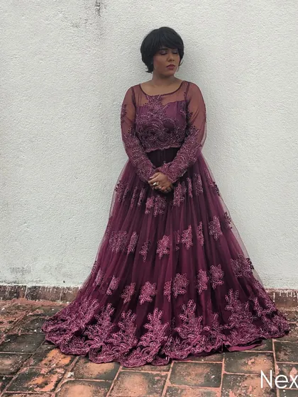 A dramatic pose in a stunning purple gown. This look is ideal for hosting formal award nights, galas, or corporate dinners.