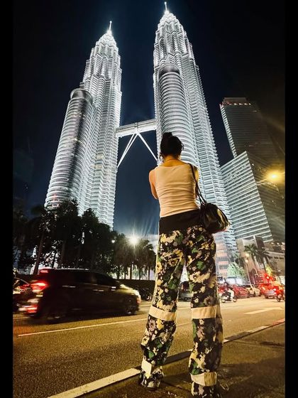 The same custom floral pants in a full-color shot. The bold pattern and relaxed fit are perfect for travel, combining comfort with a strong visual statement.