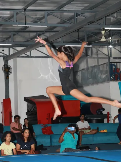 Capturing the peak of a split leap, this moment shows the combination of artistry, flexibility, and power we cultivate in our floor routines. It's about expressing joy and confidence through movement.