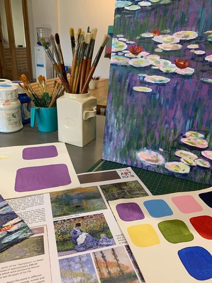 The tools of an impressionist painter. Our setup for the Monet workshop includes a palette of carefully chosen colors and reference images to study his work.