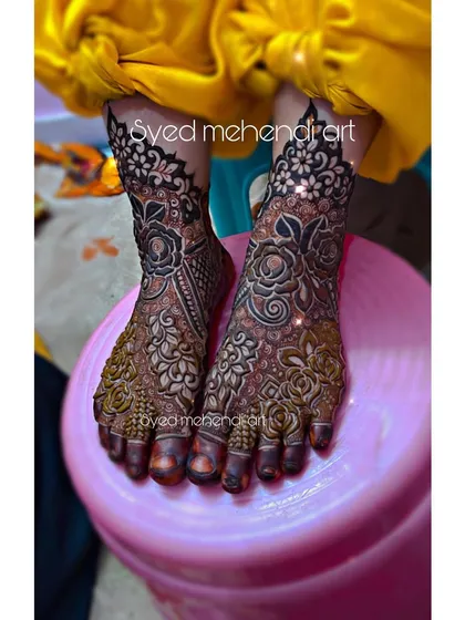Intricate bridal henna for the feet, designed to complement the hand mehndi. This design covers the entire foot and ankle with detailed floral and paisley patterns, ensuring you look beautiful from head to toe.