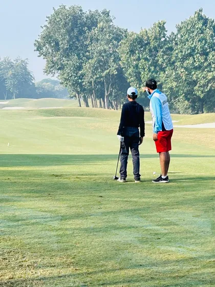 Discussing strategy on the green during the USKIDS Tour Championship. Course management is just as important as swing mechanics.