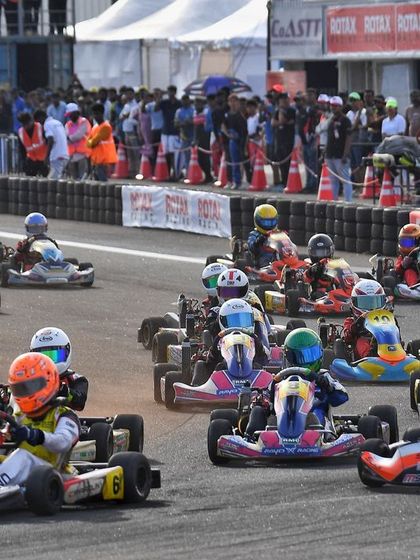 A full grid of karts streams through a corner at the CoASTT circuit. Our events attract large, competitive fields, making for spectacular racing.