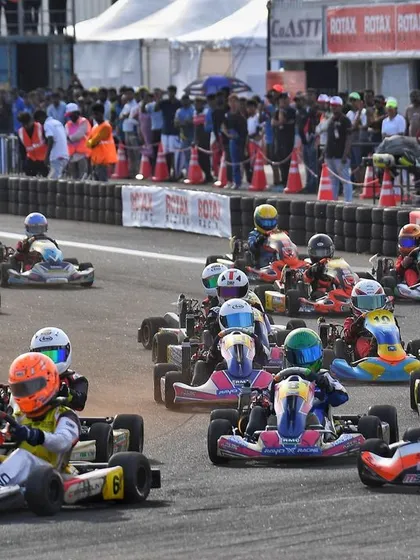 A full grid of karts streams through a corner at the CoASTT circuit. Our events attract large, competitive fields, making for spectacular racing.
