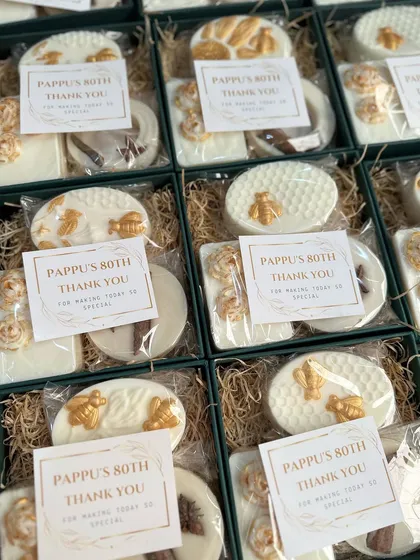 The vintage birthday favor boxes with personalized "Thank You" cards, ready for an 80th birthday celebration.