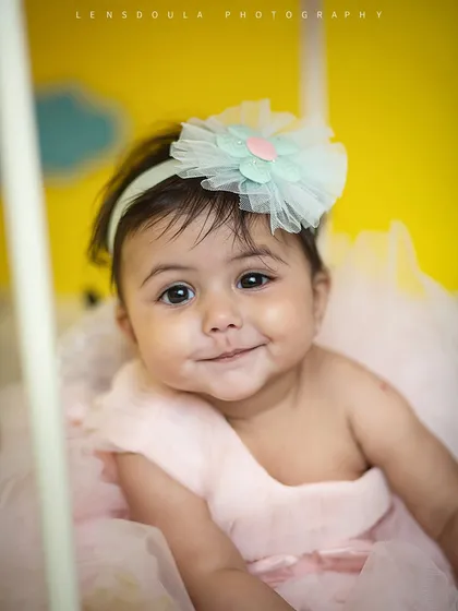 That little smirk is everything! We love capturing these fleeting expressions that showcase your baby's budding personality.