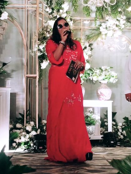 Wearing a bold red outfit, radiating energy on stage. This color is my go-to when I want to make a powerful statement.