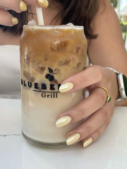 My iced coffee perfectly complements my pearly butter yellow nails.