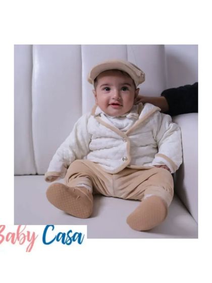 This little boy looks so dapper and comfortable in his quilted jacket and matching pants. It's a perfect outfit for a day out, keeping him warm without compromising on style.