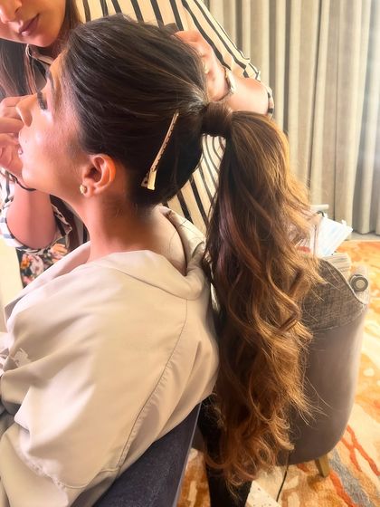 The process of styling the ponytail, ensuring every wave is perfectly in place.