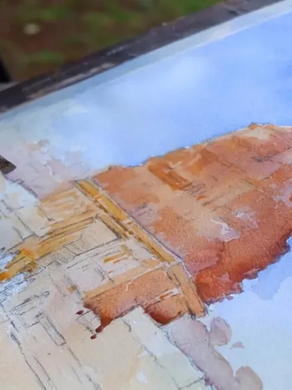 A work-in-progress shot of a watercolour landscape demonstration at the Kalakari 4 Festival in Satara, showing the initial layers of paint.