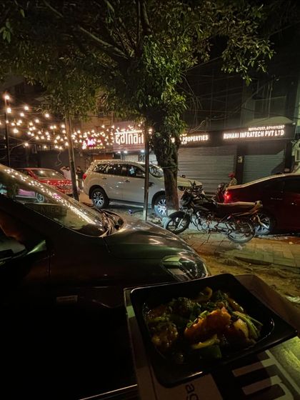 Another view of the 'Car-o-bar' setup, showcasing the convenience and enjoyment of a takeaway meal from Degnama.