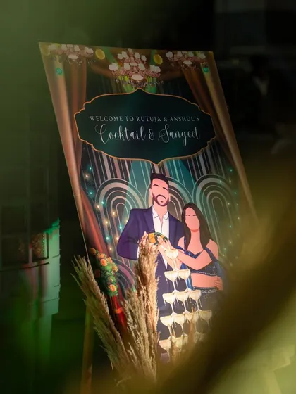Personalization is key. For this cocktail and sangeet night, I designed a custom welcome sign featuring a beautiful illustration of the couple, making the event feel truly theirs from the moment guests arrived.